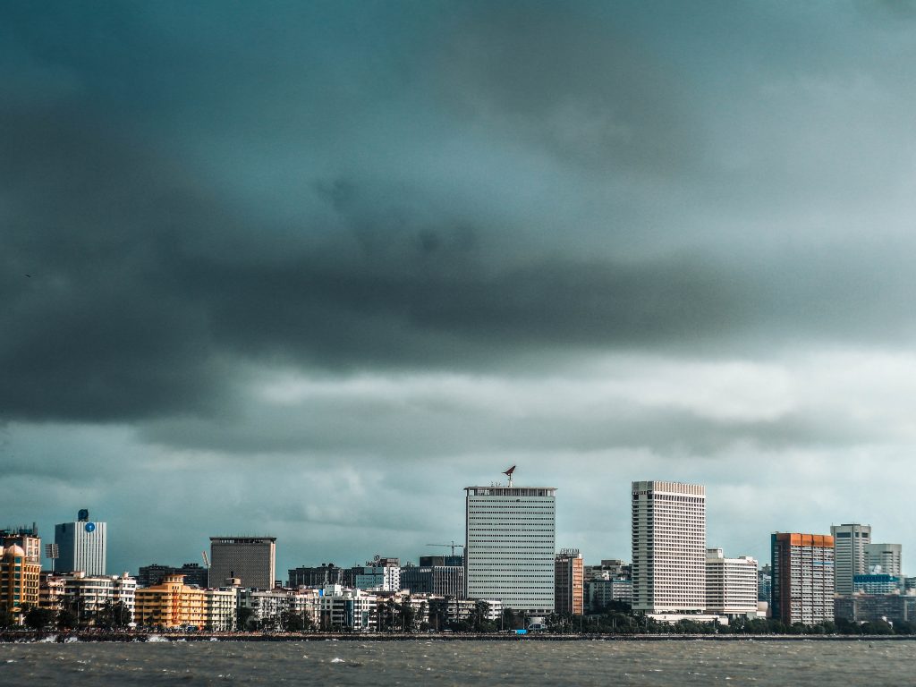 Photo of a cityscape with dark grey stormy skies.